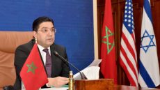 Moroccan Foreign Minister Nasser Bourita, takes part in a virtual meeting with his US and Israeli counterparts, in his office in the capital Rabat, on December 22, 2021. Morocco, Israel and the United States today marked the first anniversary of the US-sponsored resumption of diplomatic relations between the North African kingdom and the Jewish state. The foreign ministers of the three countries, Nasser Bourita, Yair Lapid and Antony Blinken, during a videoconference welcomed a partnership aimed at establishing what the US secretary of state called "an achievement that has deepened ties, partnerships, and avenues to pursue shared goals". (Photo by AFP)